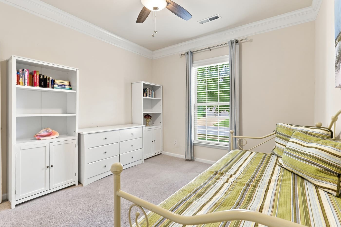 The third bedroom with built-in shelving along one wall.